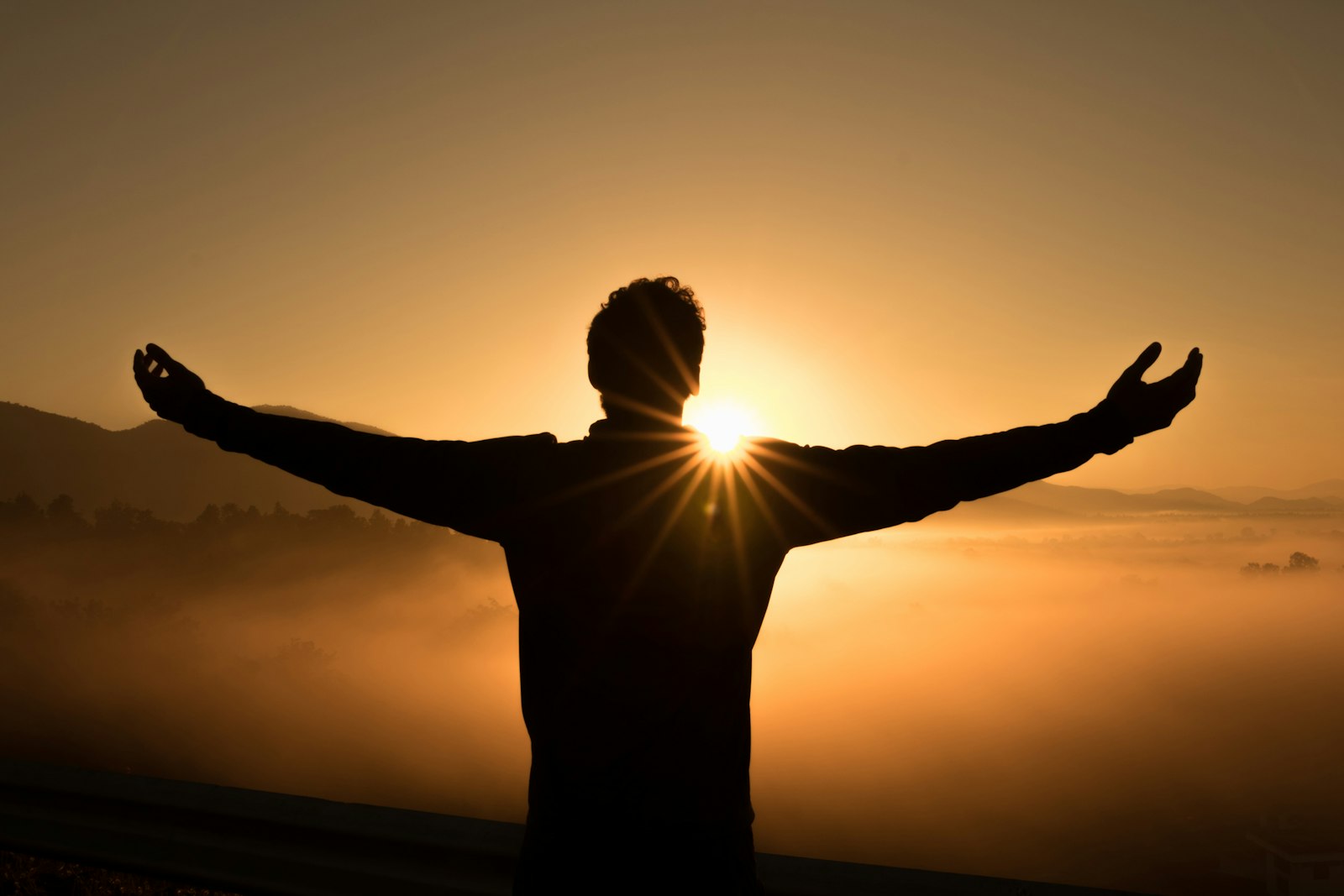 Person on mountain top at sunrise